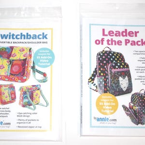 May include: Two clear plastic bags containing sewing patterns for backpacks and shoulder bags. One pattern is titled "Switchback" and the other is "Leader of the Pack." Both patterns include coupons for video tutorials and feature colorful bag designs.