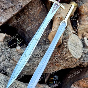 May include: Two decorative swords with silver blades and ornate handles rest on a pile of wooden logs. One sword has a gold handle and a burgundy grip, while the other has a gold handle and a silver grip. The blades have decorative etchings.