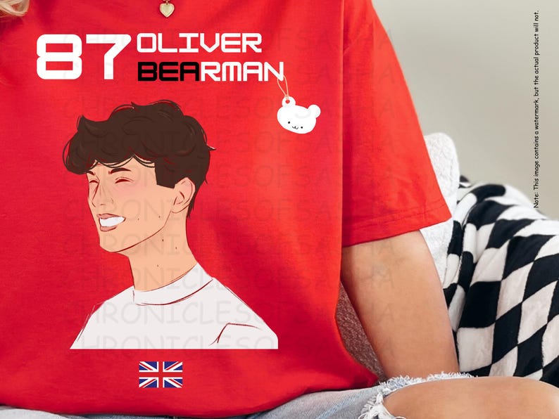 May include: Red t-shirt featuring a white illustration of a person with the text "87 OLIVER BEARMAN" and a small white bear charm.