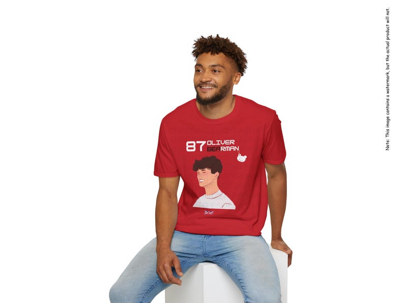 May include: A red t-shirt with a white graphic of a person's face and the text "87 Oliver Bierman".