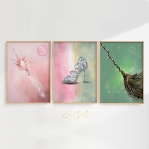 May include: Three framed art prints featuring watercolor illustrations. One shows a pink wand with a bubble, another a silver high heel, and the third a broom. The background of each print has a watercolor wash of pink, green, and yellow.