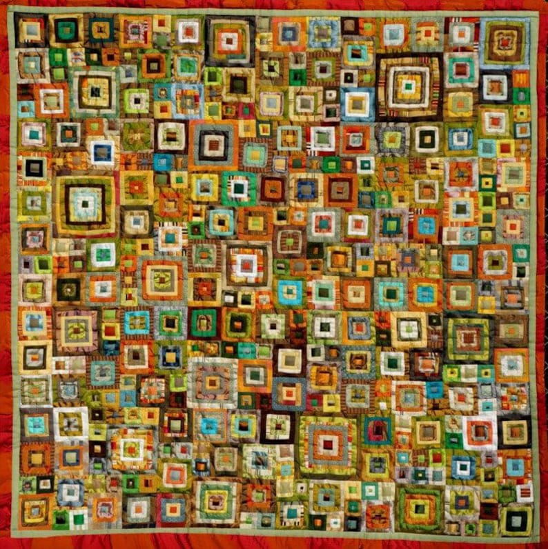 May include: A colorful quilt made of squares of fabric in various shades of brown, green, orange, and blue. The squares are arranged in a random pattern, creating a visually interesting and textured design.