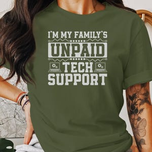 May include: A green t-shirt with the text "I'm my family's unpaid tech support" in white. The text is surrounded by a circuit board design with a laptop icon.