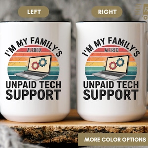 May include: White ceramic mug with a black handle and rim. The mug features the text "I'M MY FAMILY'S ALFRED UNPAID TECH SUPPORT" with a laptop graphic and a retro sunset design. The mug is a humorous gift.