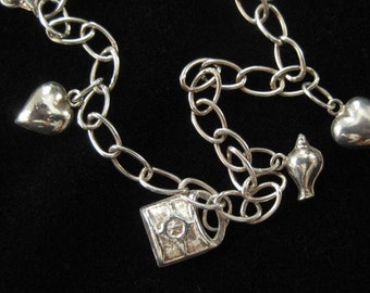 Sterling Silver Fashion Charm Bracelet with Hearts, Shells, Locks, and a Bell