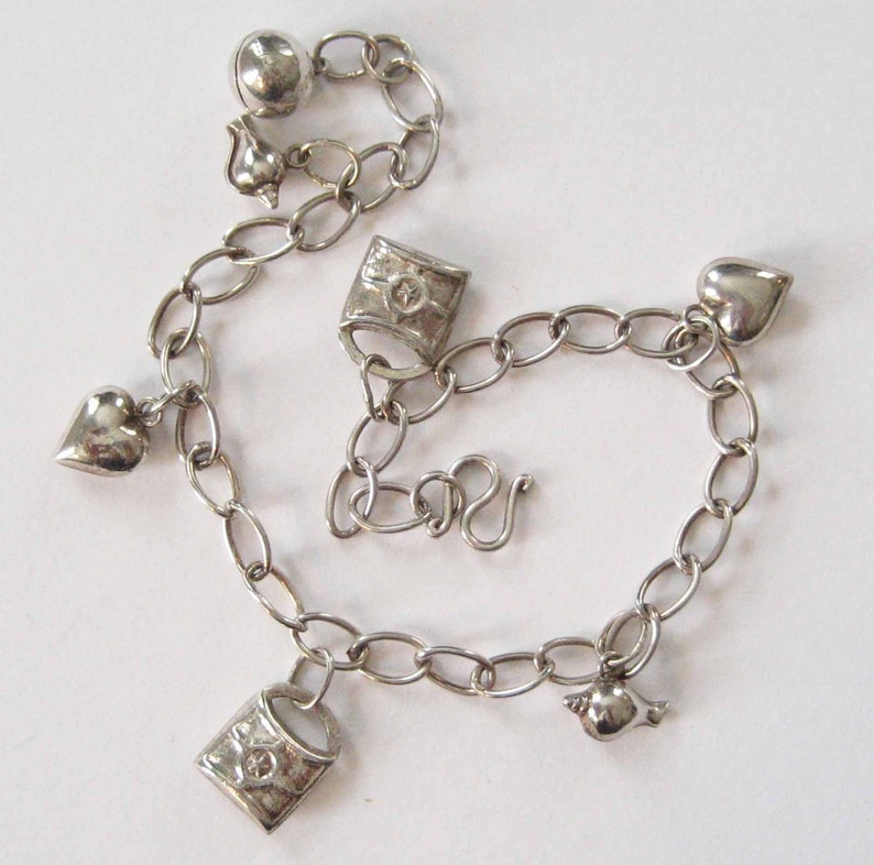 Sterling Silver Fashion Charm Bracelet With Hearts, Shells, Locks, and