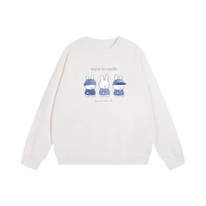 May include: A white crew neck sweatshirt with a blue illustration of three cartoon bunnies. The text "wave to earth" is above the bunnies, and "flower and all" is below. The bunnies are wearing blue outfits.