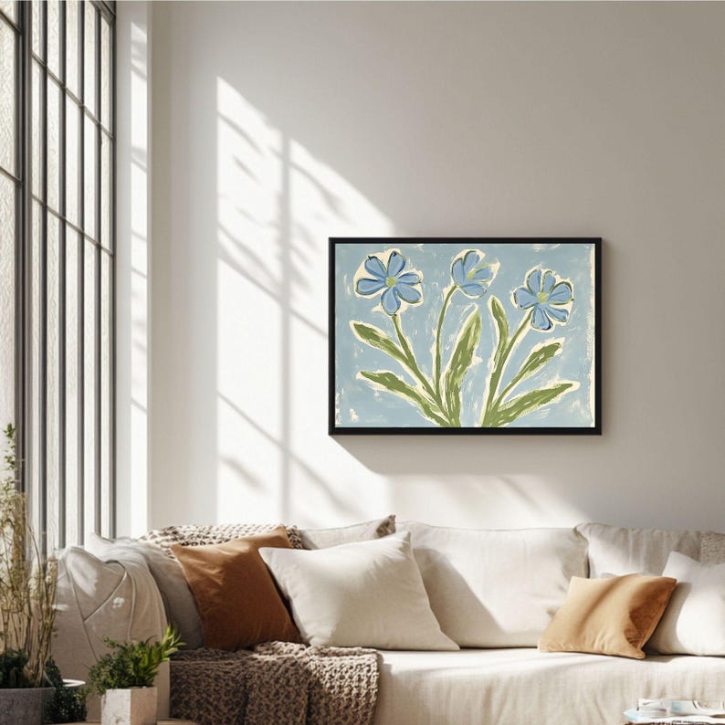 Puede incluir: Una pintura enmarcada de tres flores azules con tallos y hojas verdes sobre un fondo azul claro.