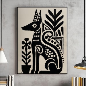 May include: Black and white art print featuring a stylized dog with decorative patterns and plant motifs. The artwork is framed in a black border, creating a striking contrast against the neutral background. The dog is depicted in a seated position.