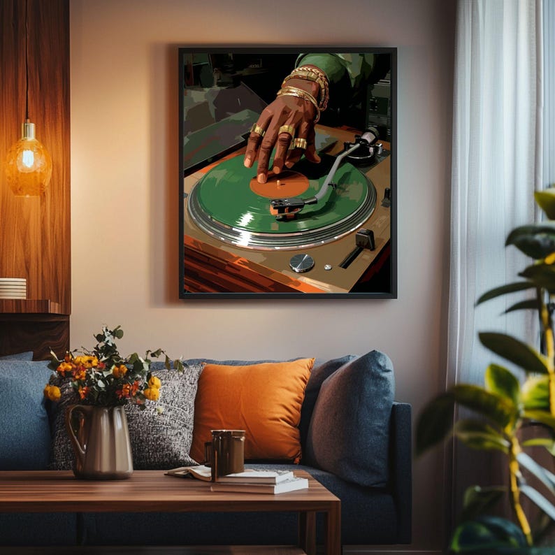 May include: A framed art print depicts a DJ's hand on a green vinyl record. The DJ's hand is adorned with gold rings and bracelets. The turntable is set against a neutral background, creating a modern, artistic vibe.
