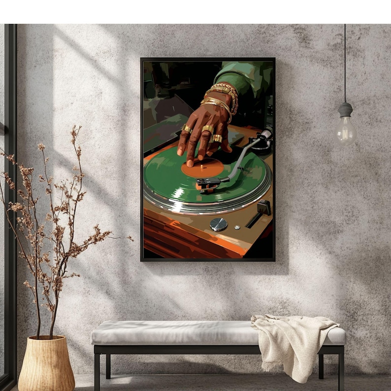 May include: A framed art print depicts a DJ's hand adorned with gold jewelry, manipulating a green vinyl record on a turntable. The artwork features a warm color palette with shades of brown, green, and gold, creating a retro vibe. The image is set against a textured gray wall.