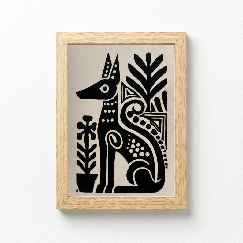 May include: A framed black and white art print featuring a stylized dog with decorative floral elements. The dog is sitting, with a long snout and pointed ears. The artwork is in a light wood frame.