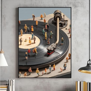 May include: Framed artwork showing a vintage record player with miniature figures on the record and turntable. The figures are dressed in various colours, creating a whimsical scene. The record player's arm and needle are visible.