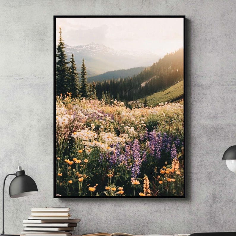 May include: A scenic landscape photograph featuring a field of wildflowers in shades of purple, yellow, and white, with a mountain range in the background. The sun is setting, casting a warm glow over the scene.