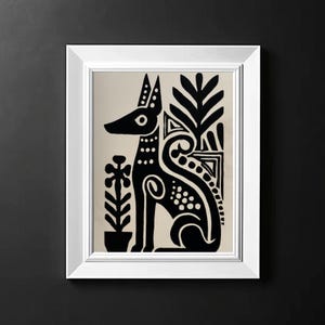 May include: A framed art print featuring a stylized black dog with decorative patterns, set against a beige background. The artwork includes plant motifs and is enclosed in a white frame, creating a striking contrast against the dark background.