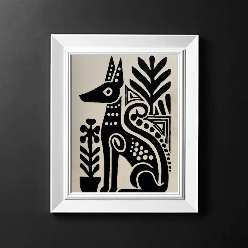 May include: A framed art print featuring a stylized black dog with decorative patterns, set against a beige background. The artwork includes plant motifs and is enclosed in a white frame, creating a striking contrast against the dark background.