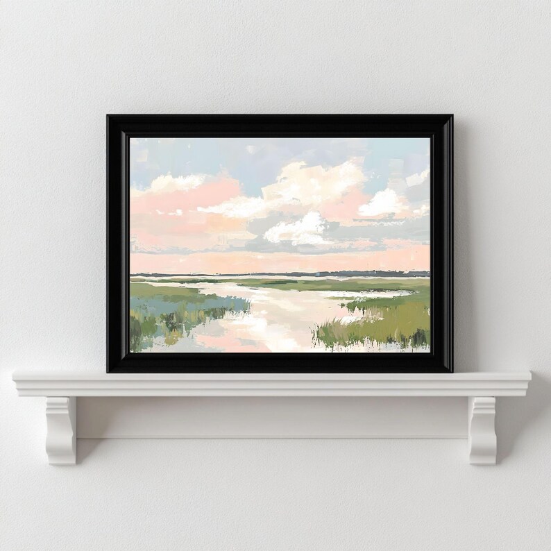 May include: A framed painting of a landscape with a river flowing through a field of green grass. The sky is a soft blue with pink clouds.