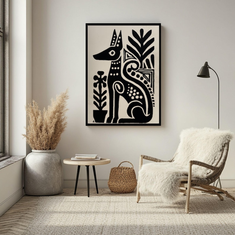 May include: Black and white framed art print featuring a stylized dog illustration. The dog is depicted in a seated position with decorative patterns and plant motifs. The artwork is displayed in a well-lit room with neutral tones.