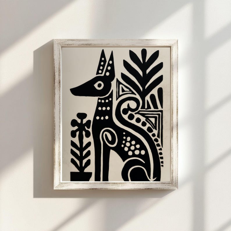 May include: Black and white framed art print featuring a stylized dog illustration. The dog is depicted in a seated position with decorative floral and geometric elements. The artwork is framed in a white, distressed-look wooden frame.