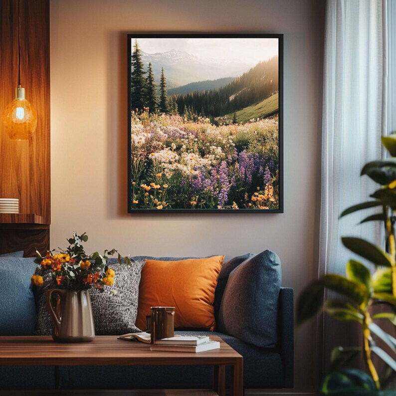 May include: A framed photograph of a mountain meadow with a variety of wildflowers in bloom. The meadow is bathed in warm sunlight, with a mountain range in the background.