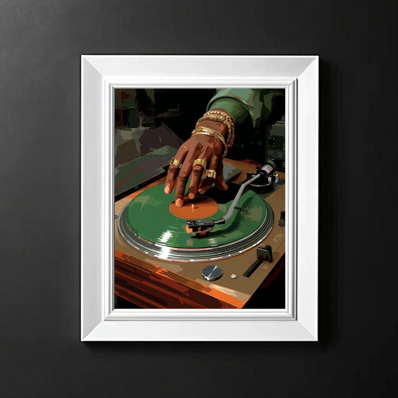 May include: A framed print of a DJ at work. The image features a hand adorned with gold rings and bracelets, positioned over a green vinyl record on a turntable. The artwork has a warm color palette with shades of brown, green, and gold.