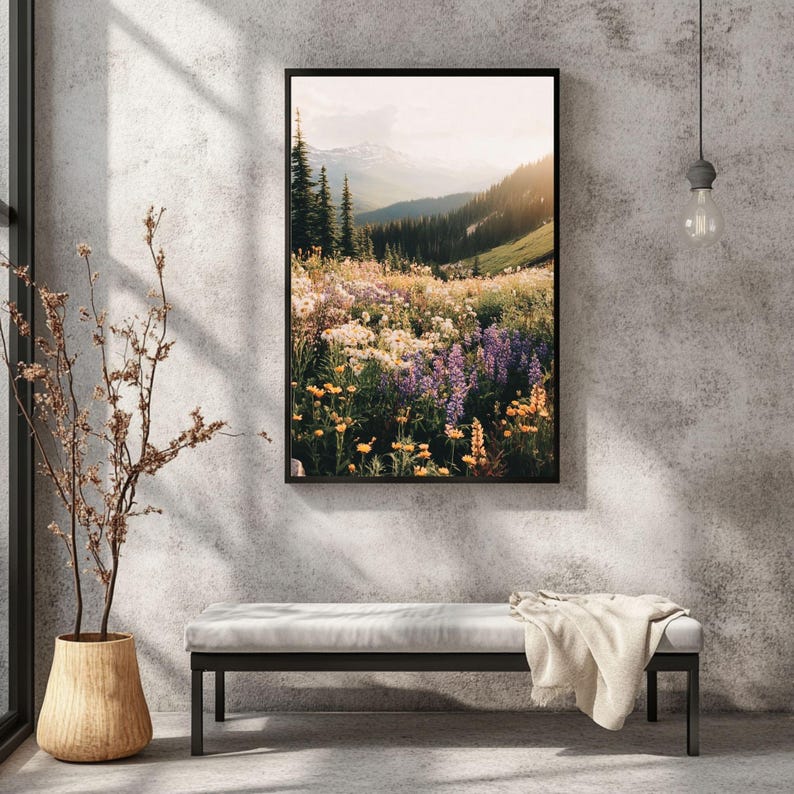 May include: A framed photograph of a mountain meadow with wildflowers in shades of purple, yellow, and white. The meadow is surrounded by trees and mountains in the background.
