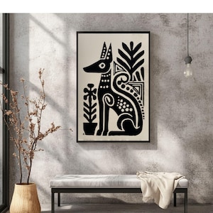 May include: Black and white framed art print featuring a stylized dog illustration. The dog is depicted in a seated position with decorative patterns and plant elements. The artwork is set against a cream background.
