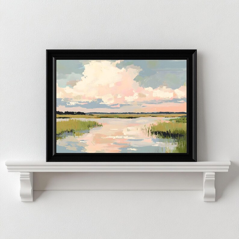 May include: A framed painting depicting a landscape with a river and green reeds in the foreground. The sky is a soft blue with pink and white clouds.