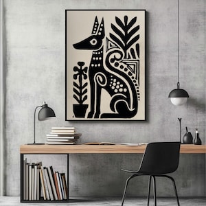 May include: Black and white art print featuring a stylized dog with decorative elements and plants. The artwork is framed and displayed on a wall above a wooden desk with books and a black chair. The room has a modern, minimalist aesthetic.