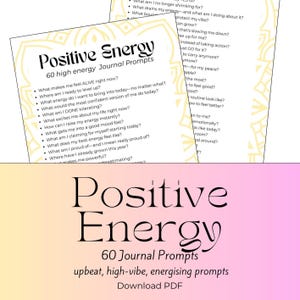 May include: Two white journal pages with the words "Positive Energy" and "60 high energy Journal Prompts" in black. The pages contain a list of prompts for self-reflection. The background is a gradient of pink and yellow.