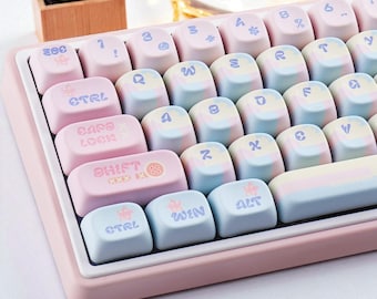 May include: A pastel-colored mechanical keyboard with a pink frame. The keycaps are a mix of light pink, blue, and yellow, with symbols and text like "CTRL", "SHIFT", and "WIN". The keyboard has a minimalist design.