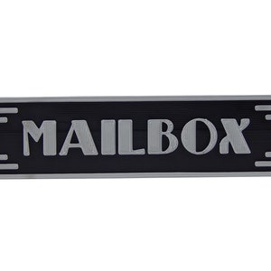 May include: A silver metal mailbox sign with black background and the word "MAILBOX" in raised silver letters.