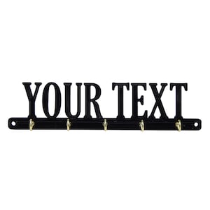 May include: Black metal key rack with five hooks and the text "YOUR TEXT" in large, bold letters.