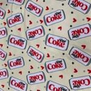 May include: Cream-colored fabric with a repeating pattern of red and white "Coke" soda can illustrations and small red hearts. The cans are tilted at various angles, creating a playful and dynamic design.
