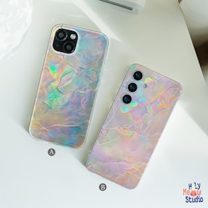 May include: Two iridescent phone cases with a textured, flowing design. The case on the left has a dual-lens camera, while the one on the right has a triple-lens camera. The cases are labeled A and B, with the Holy Meow Studio logo in the bottom right.