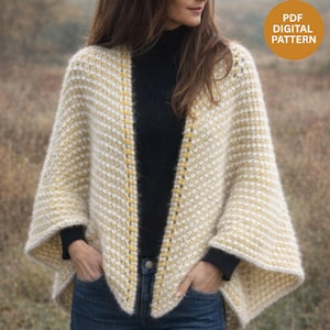 Peut inclure: Un poncho crème à rayures diagonales crème et jaune, avec une texture en relief. Le vêtement à devant ouvert est fait d'une laine épaisse et a une coupe décontractée. Le texte "PDF DIGITAL PATTERN" est inclus.