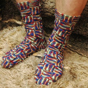 May include: A pair of colorful socks with a geometric pattern in shades of blue, red, green, and white. The socks are knitted and have a textured look.