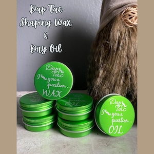 May include: Six small green metal tins with screw-on lids. The lids have white text that reads "Dap Tac I you a question..." and either "WAX" or "OIL".