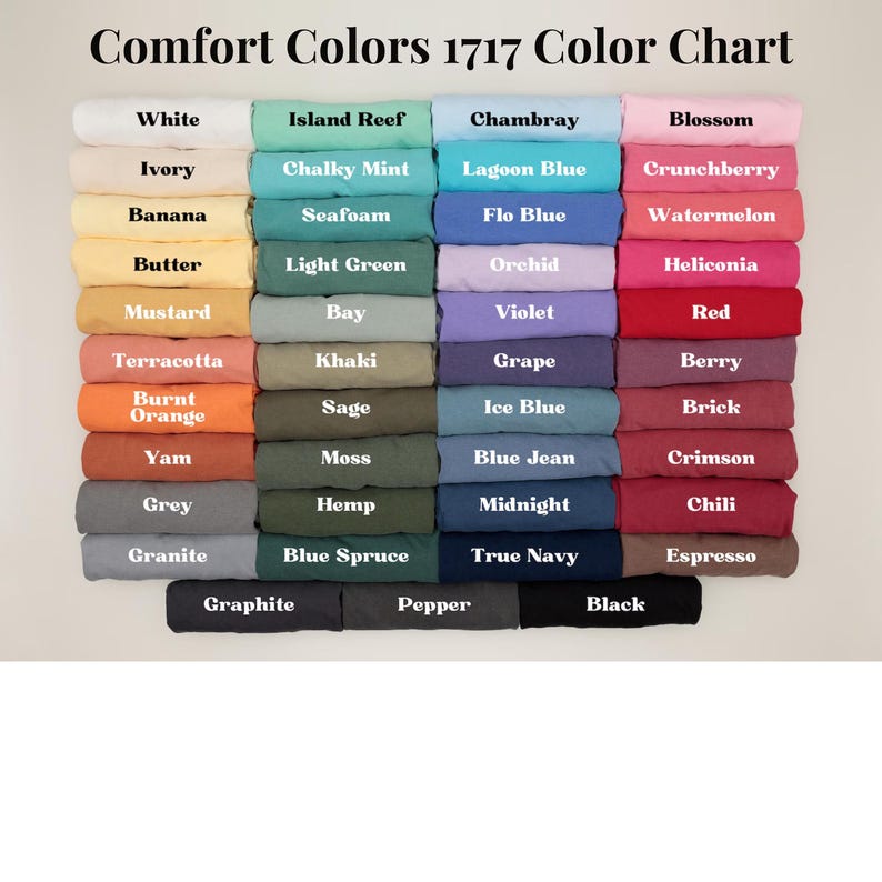 May include: A color chart displaying a range of Comfort Colors 1717. The chart features various colors, including white, ivory, banana, butter, mustard, terracotta, burnt orange, yam, grey, and granite. The text "Comfort Colors 1717 Color Chart" is at the top.