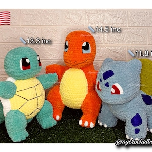 May include: Three crocheted plush toys: a teal turtle (13.3 inches), an orange Charmander (14.5 inches), and a blue Bulbasaur (11.8 inches). Each plush has distinct features and colors, with the turtle having a yellow shell and the Charmander a yellow belly.