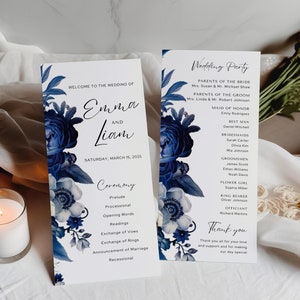 May include: Wedding ceremony program with blue floral designs. The program lists the order of events for the ceremony, including the prelude, processional, readings, exchange of vows, and recessional. The program also includes a wedding party list with the names of the maid of honor, best man, bridesmaids, groomsmen, flower girl, ring bearer, and officiant.