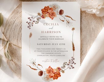 May include: A wedding invitation featuring the names "Cecilia" and "Harrison" in elegant script, surrounded by a floral wreath of orange and white roses and dried foliage. The invitation includes the date, time, and location of the ceremony.