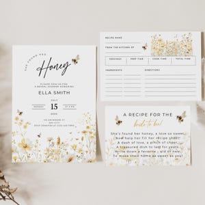 May include: Bridal shower invitation set with a floral and bee theme. The invitation reads "She found her Honey" and includes details for Ella Smith's shower on July 15th. Includes a recipe card and a card with a poem.