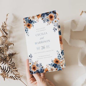 May include: A wedding invitation with floral accents in shades of blue, orange, and white. The invitation reads "Welcome to the wedding of Cecilia and Harrison" with the date "Sat 26 Jul". The Rosewood Estate, Charleston, South Carolina is also listed.
