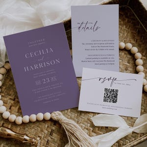 May include: A wedding invitation suite comprising a purple invitation card with the names Cecilia and Harrison, a details card, and an RSVP card with a QR code. The cards are on a woven tray with wooden beads and a tassel.