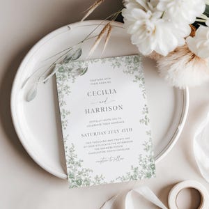 Editable green toile wedding invitation template featuring sage chinoiserie floral design, vintage French toile de Jouy pattern, and traditional elegant wedding card style