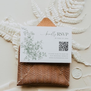 May include: A wedding RSVP card with floral design and the text "kindly RSVP". The card includes a QR code and website address. It rests on a textured brown envelope with a white wax seal.