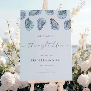 May include: A white wedding welcome sign featuring watercolor oyster designs. The sign says "Welcome to the night before", celebrating Isabella & Noah, July 15, 20XX, at The Bluebell Estate. The sign is displayed on a wooden easel.