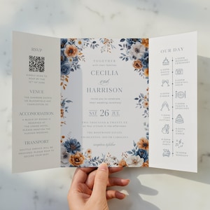 May include: A tri-fold wedding invitation with floral accents in navy blue, white, and gold. The invitation includes the names Cecilia and Harrison, the date, and a wedding day timeline. The RSVP and venue details are also included.