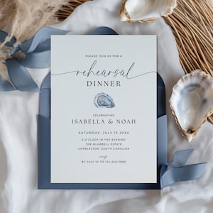 May include: A formal invitation for a rehearsal dinner, featuring elegant script and a watercolor oyster illustration. The invitation is in a blue envelope, with details including the names Isabella & Noah, date, time, and location.